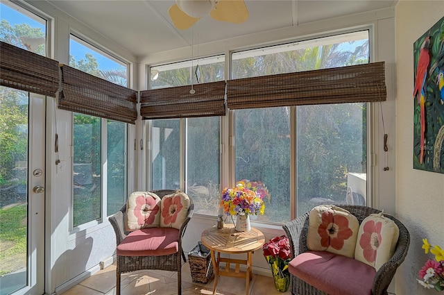 sunroom / solarium featuring ceiling fan