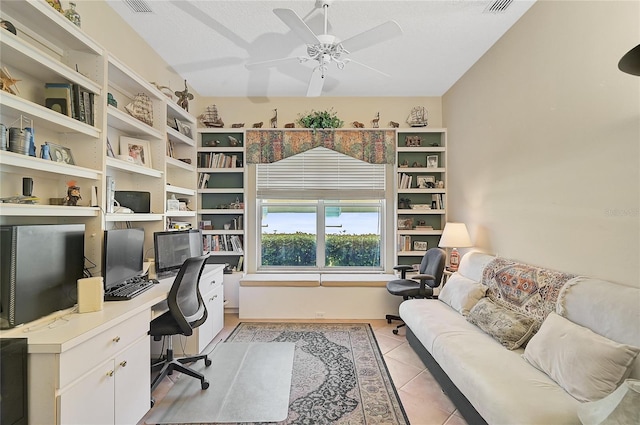 office space featuring a textured ceiling, ceiling fan, and light tile patterned flooring