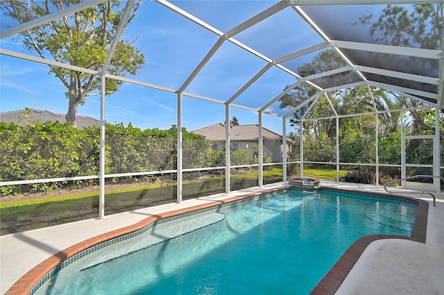 view of pool featuring glass enclosure and a patio area