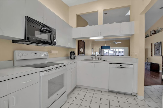 kitchen with white appliances, sink, ceiling fan, light tile patterned floors, and white cabinetry