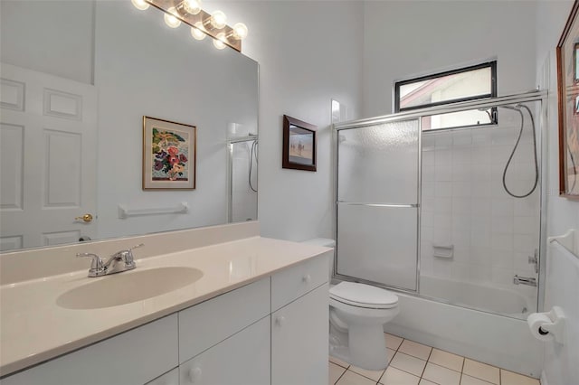 full bathroom with tile patterned floors, vanity, bath / shower combo with glass door, and toilet