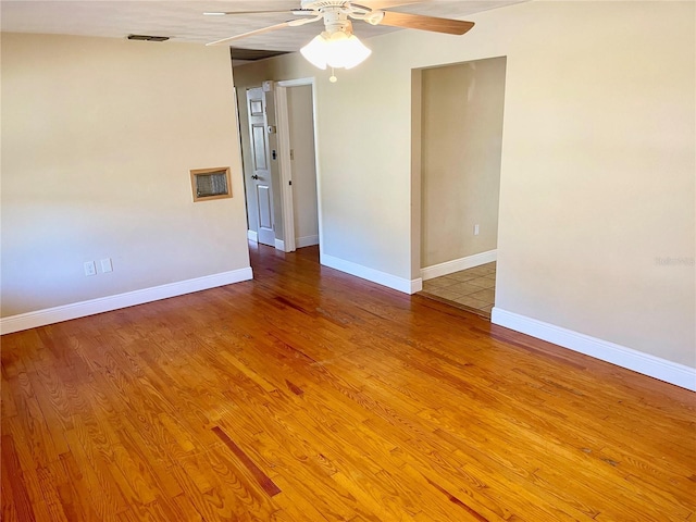 spare room with ceiling fan and wood-type flooring