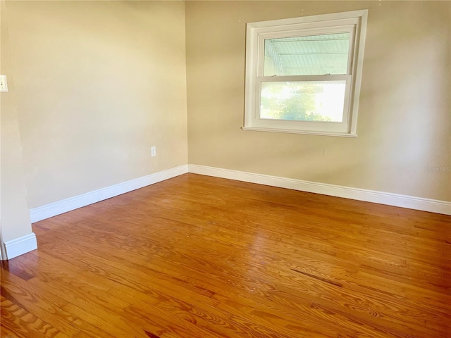 empty room with hardwood / wood-style floors