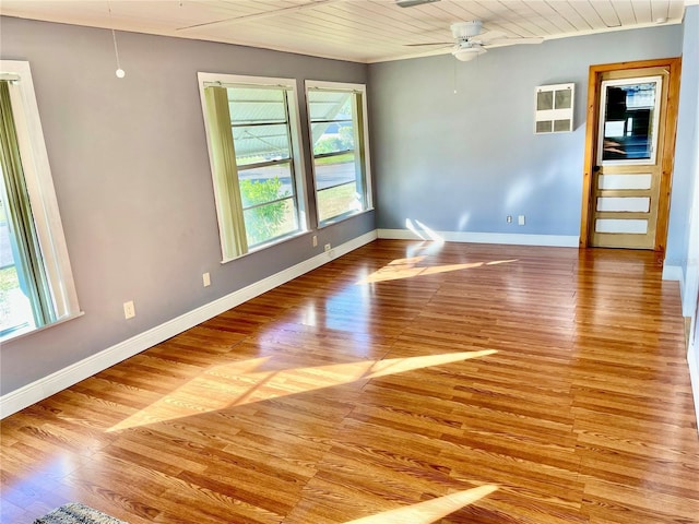 empty room featuring plenty of natural light, light hardwood / wood-style floors, and ceiling fan