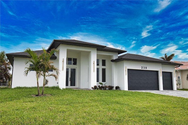 view of front of house with a front yard and a garage