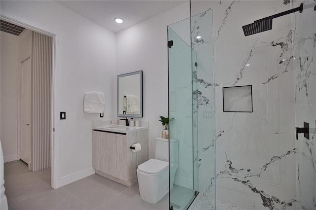 bathroom featuring tile patterned floors, vanity, toilet, and a shower with shower door