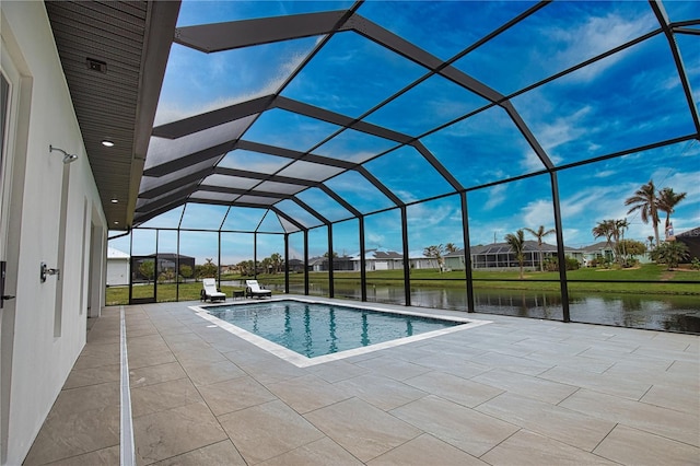 view of swimming pool featuring a water view, a patio area, and a lanai