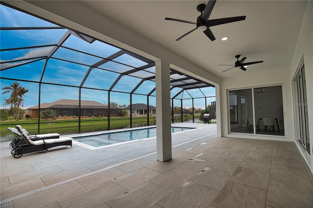 view of pool with a patio, ceiling fan, and a lanai