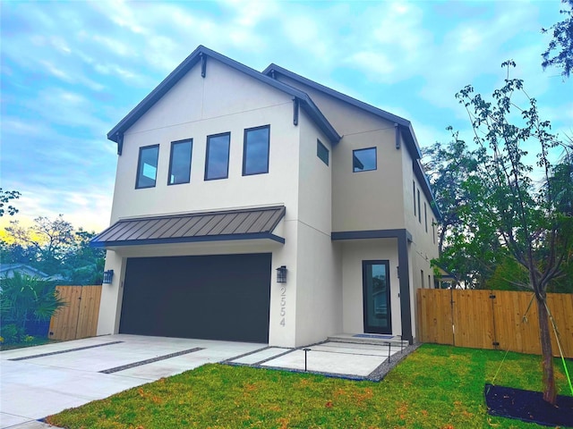 view of front of home with a garage and a front yard