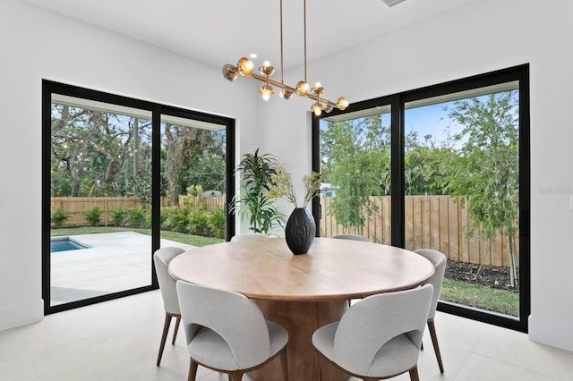 dining room featuring light tile patterned flooring and a notable chandelier