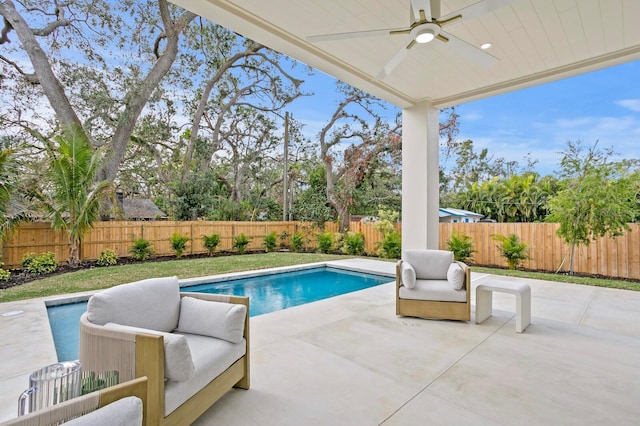 view of swimming pool with ceiling fan and a patio area