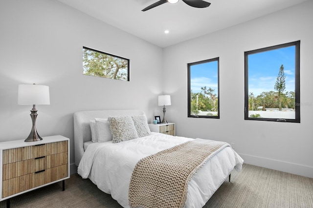 bedroom with dark colored carpet and ceiling fan