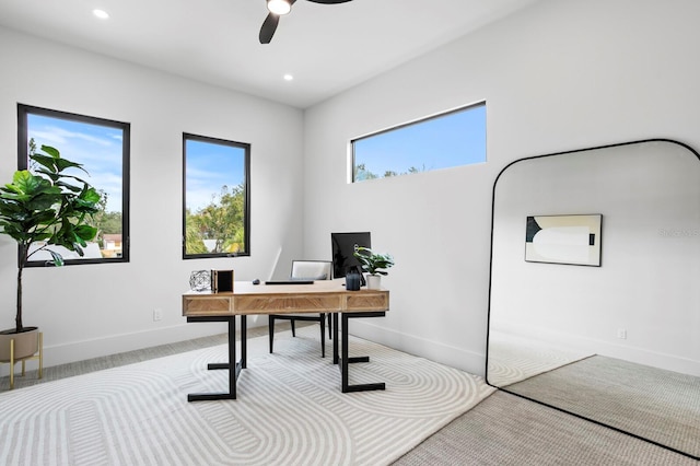 carpeted office space featuring a wealth of natural light and ceiling fan