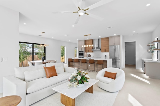 living room with ceiling fan with notable chandelier