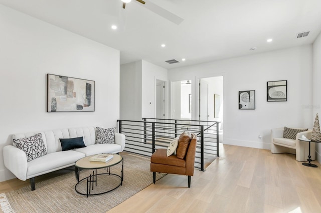 living room featuring ceiling fan and light wood-type flooring