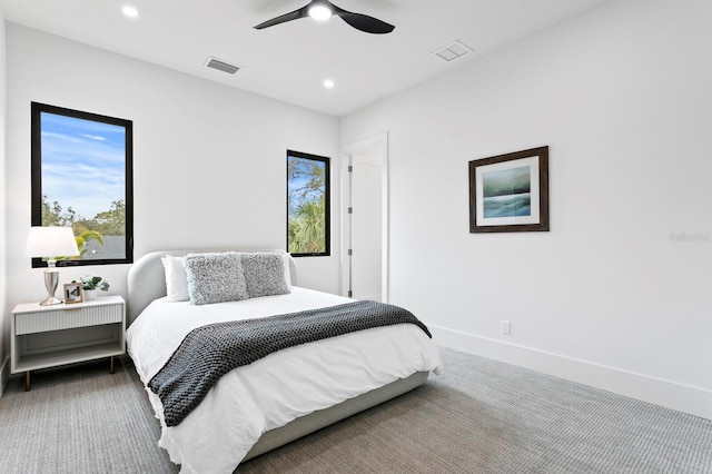 bedroom featuring ceiling fan, carpet floors, and multiple windows