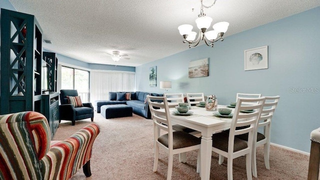 dining space featuring ceiling fan with notable chandelier, light colored carpet, and a textured ceiling