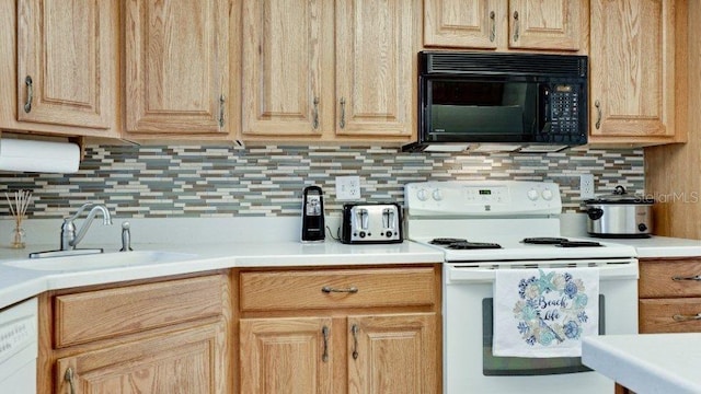 kitchen featuring white appliances, backsplash, and sink