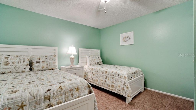 carpeted bedroom featuring ceiling fan and a textured ceiling