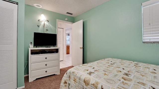 carpeted bedroom featuring multiple windows and a textured ceiling