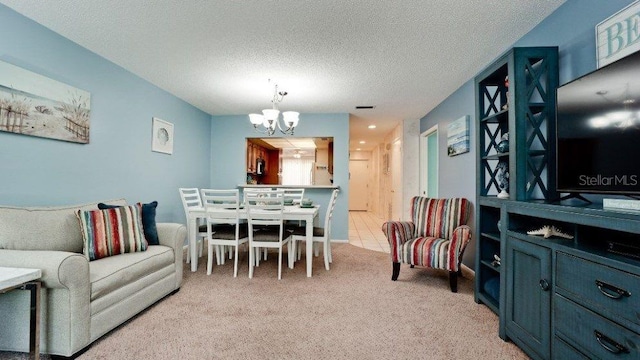 carpeted dining space with a textured ceiling and an inviting chandelier