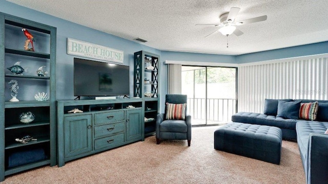 living room with ceiling fan, light colored carpet, and a textured ceiling