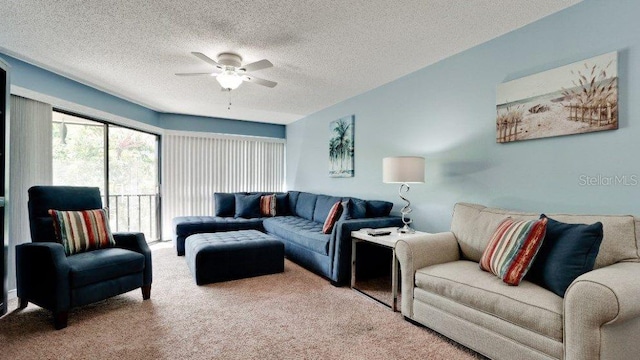 living room featuring carpet flooring, ceiling fan, and a textured ceiling