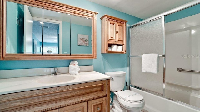 full bathroom with toilet, combined bath / shower with glass door, and vanity