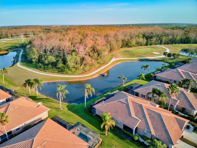 aerial view featuring a water view, golf course view, and a view of trees