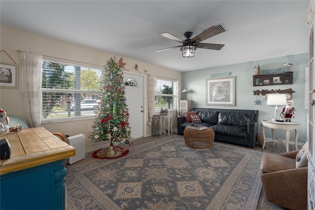 living room featuring dark hardwood / wood-style floors and ceiling fan