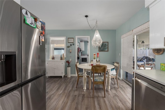 dining room featuring wood-type flooring and a notable chandelier