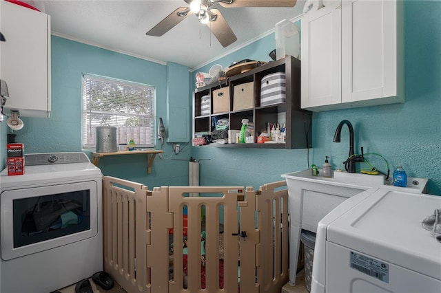 laundry room with separate washer and dryer, crown molding, cabinets, and a textured ceiling