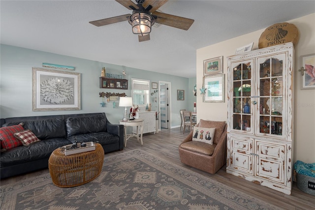 living room featuring dark hardwood / wood-style floors and ceiling fan