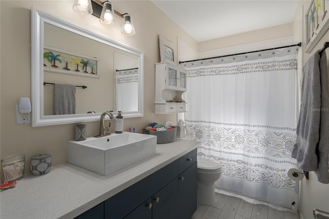 bathroom featuring hardwood / wood-style floors, vanity, and toilet