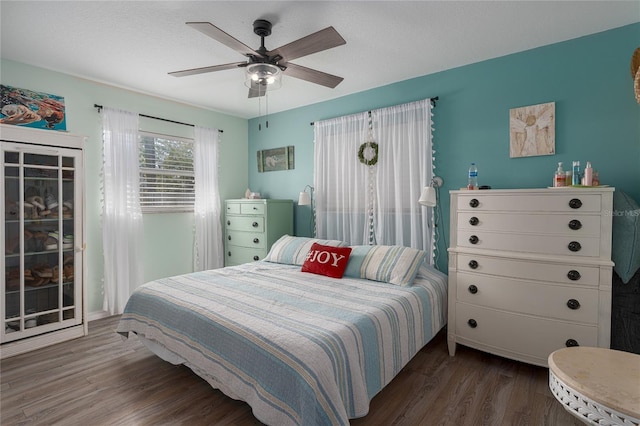 bedroom featuring ceiling fan and dark hardwood / wood-style floors