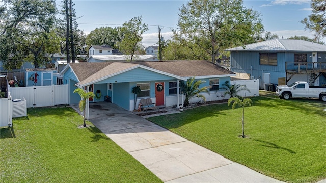 view of front of house with a front yard and a carport