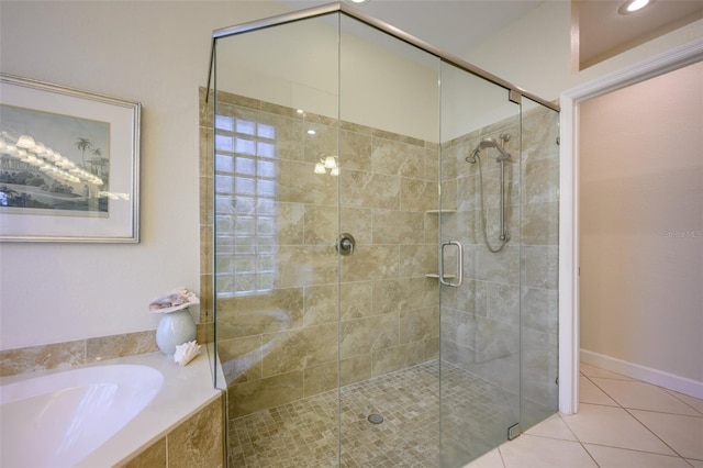 bathroom featuring tile patterned floors and independent shower and bath