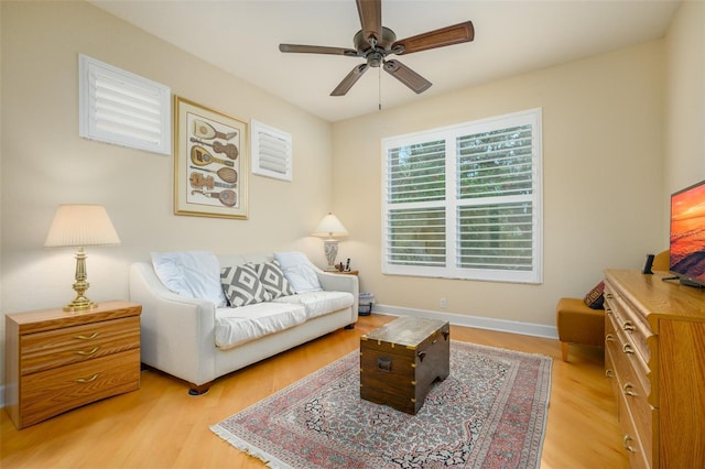 living room with ceiling fan and light wood-type flooring