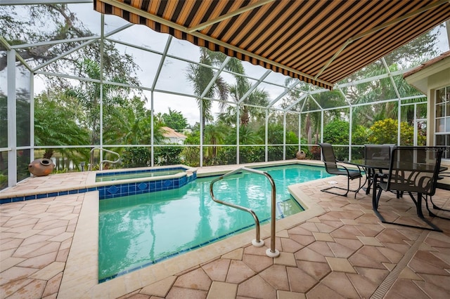 view of swimming pool with glass enclosure, a patio area, and an in ground hot tub