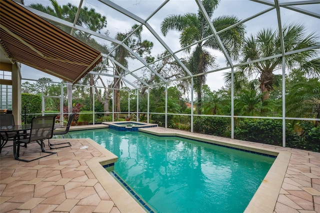 view of swimming pool with a lanai, an in ground hot tub, and a patio