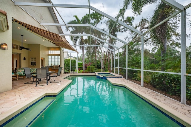 view of swimming pool featuring a lanai, a patio area, and an in ground hot tub