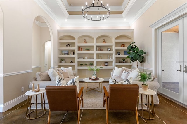 sitting room with an inviting chandelier, built in features, and a tray ceiling