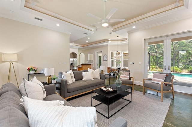 living room featuring ceiling fan, french doors, crown molding, and a tray ceiling