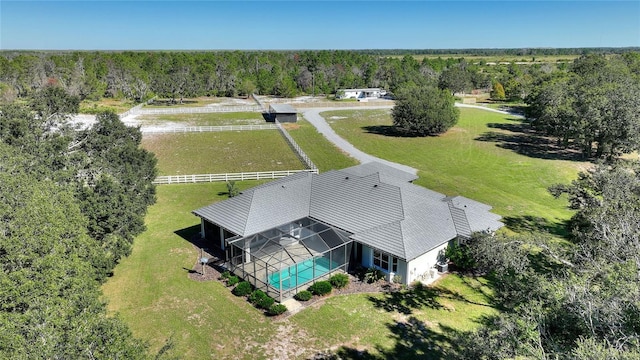 drone / aerial view with a wooded view