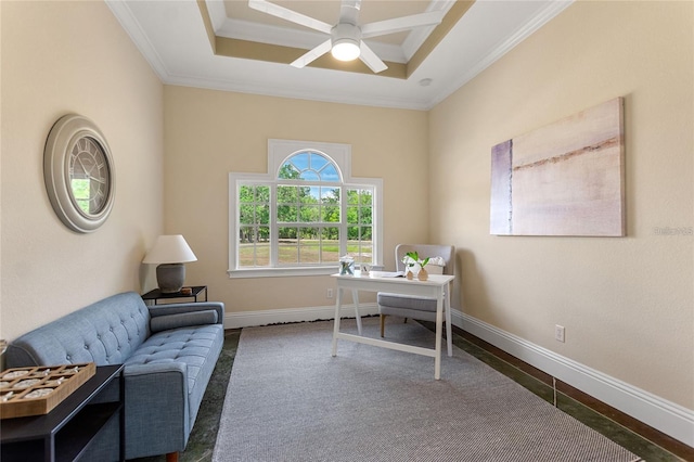 office featuring ornamental molding, a raised ceiling, baseboards, and a ceiling fan