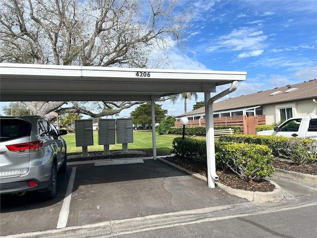 view of vehicle parking with mail boxes