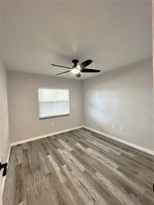 unfurnished room featuring ceiling fan and dark hardwood / wood-style floors