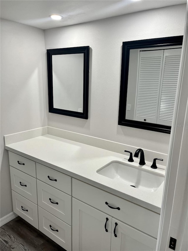 bathroom with vanity and hardwood / wood-style flooring