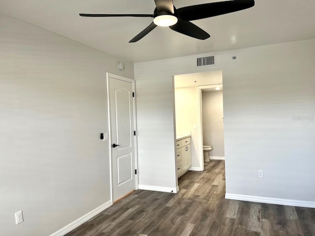 empty room featuring dark hardwood / wood-style flooring and ceiling fan