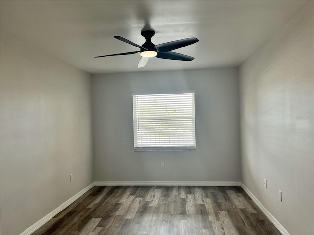 empty room with ceiling fan and dark wood-type flooring